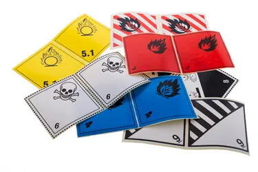 Safety labels and signs in various colours to inform about hazards and precautions in laboratories and industries